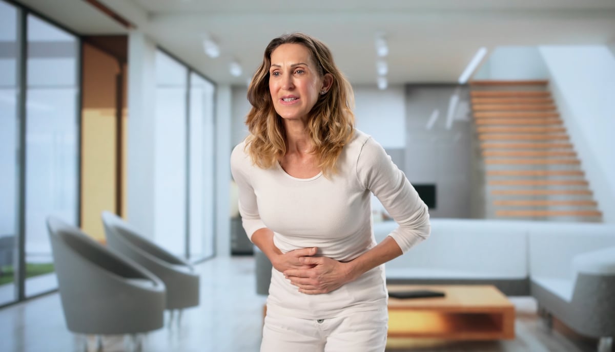 Woman dealing with gut health issues looking worried
